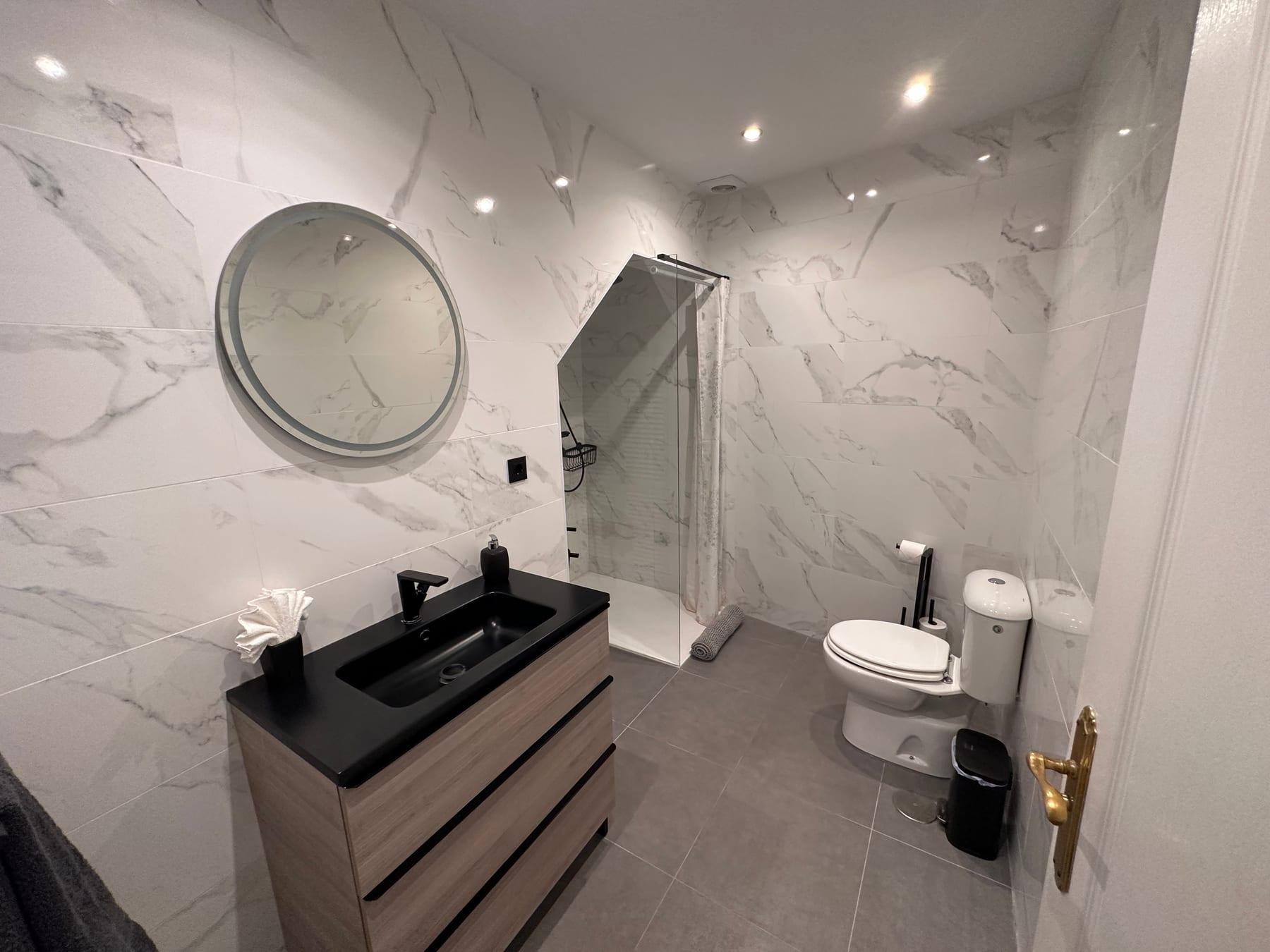 Marble bathroom with vanity and shower