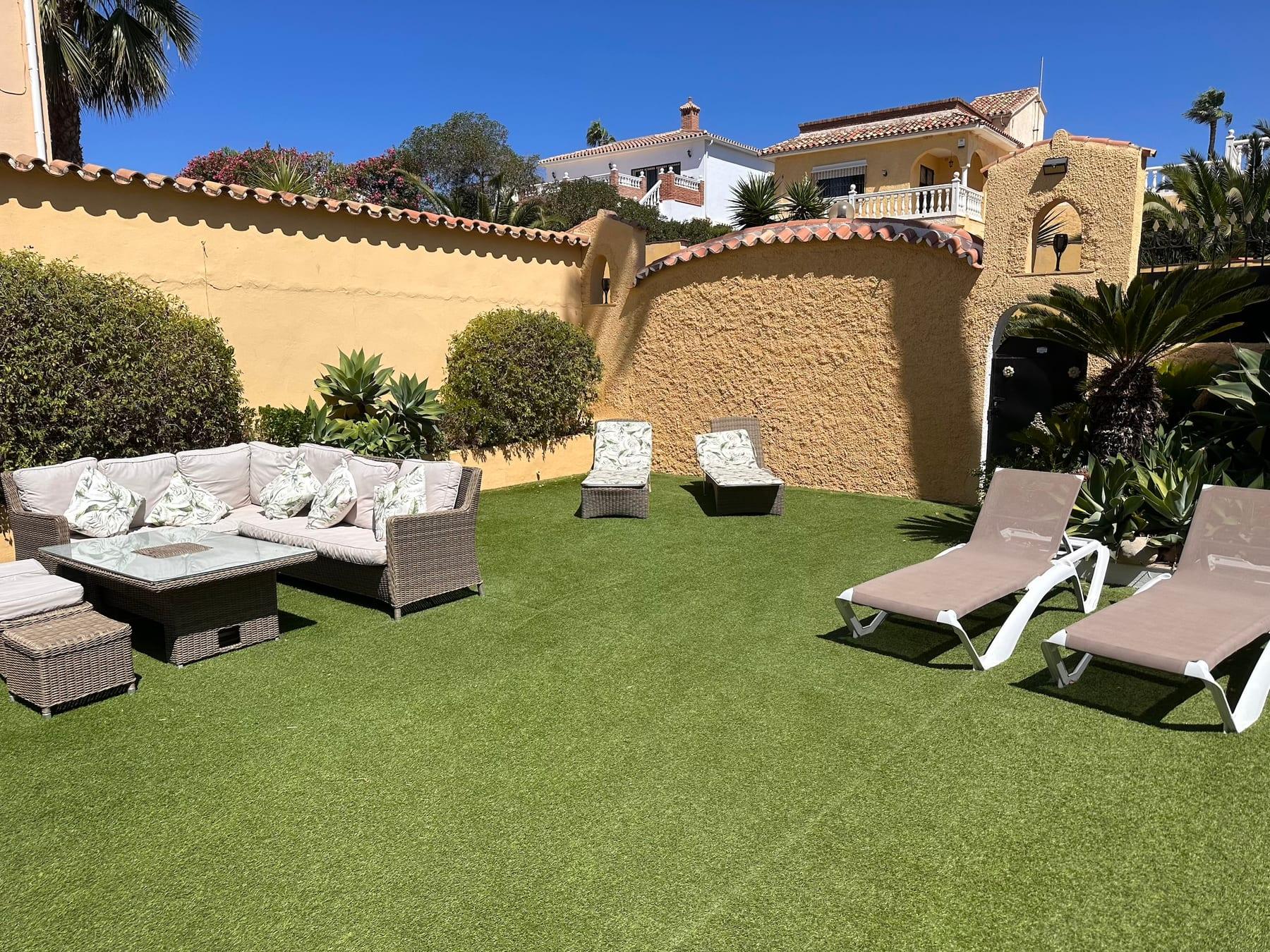 Garden with sun loungers and outdoor seating
